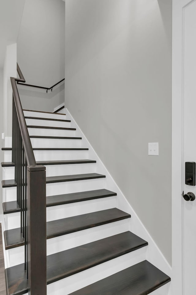 stairway featuring wood finished floors