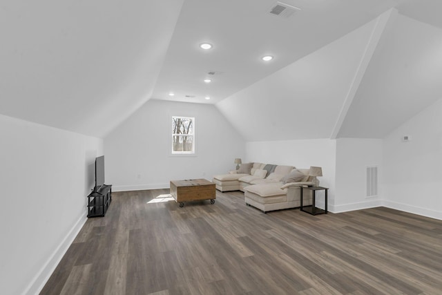 living room with dark wood finished floors, visible vents, baseboards, and lofted ceiling