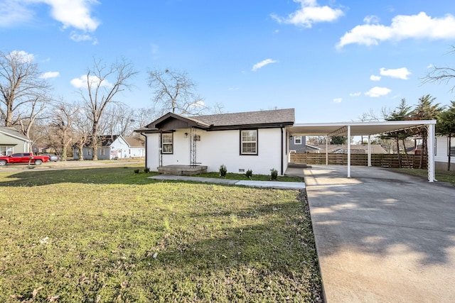 view of front facade with a front lawn, fence, crawl space, a carport, and driveway