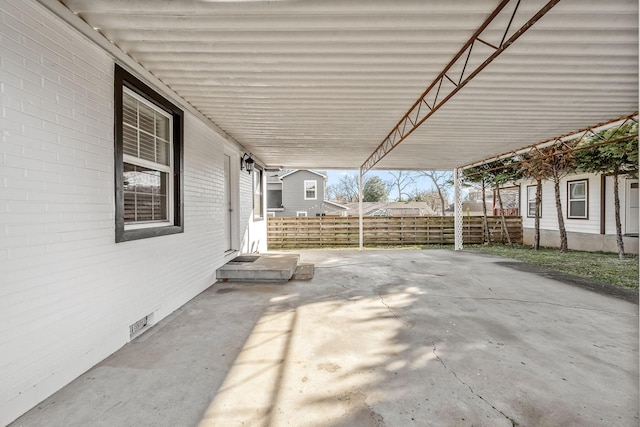 view of patio / terrace with a carport and fence