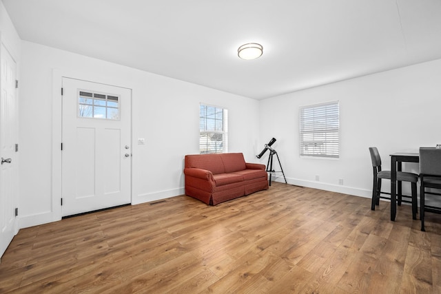 entrance foyer with visible vents, light wood-style flooring, and baseboards