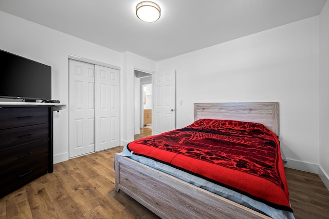 bedroom featuring a closet, baseboards, and wood finished floors