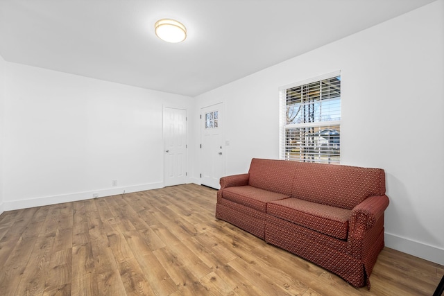 living area with baseboards and light wood-style floors