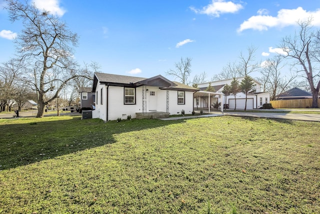 view of front of home with crawl space, a garage, a front yard, and fence