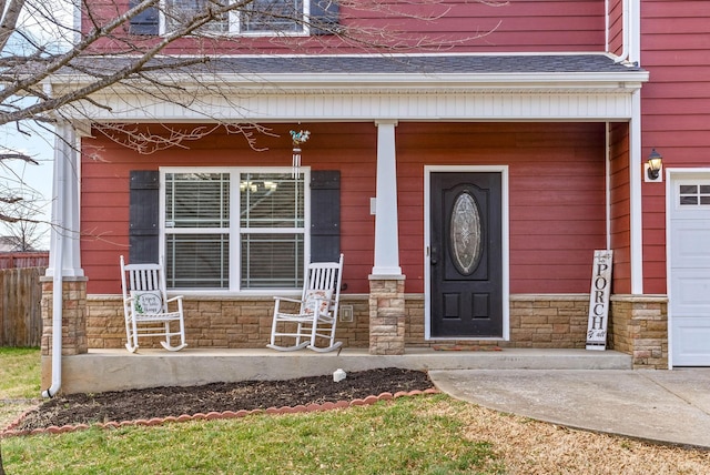 property entrance featuring a porch and stone siding