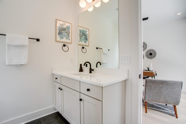 bathroom with baseboards and vanity