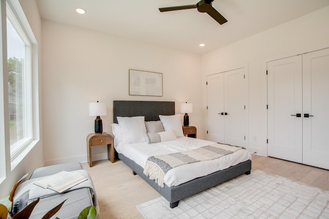 bedroom featuring recessed lighting, multiple windows, and multiple closets