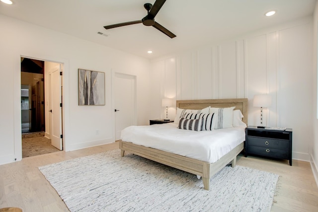 bedroom featuring a ceiling fan, visible vents, light wood finished floors, baseboards, and recessed lighting