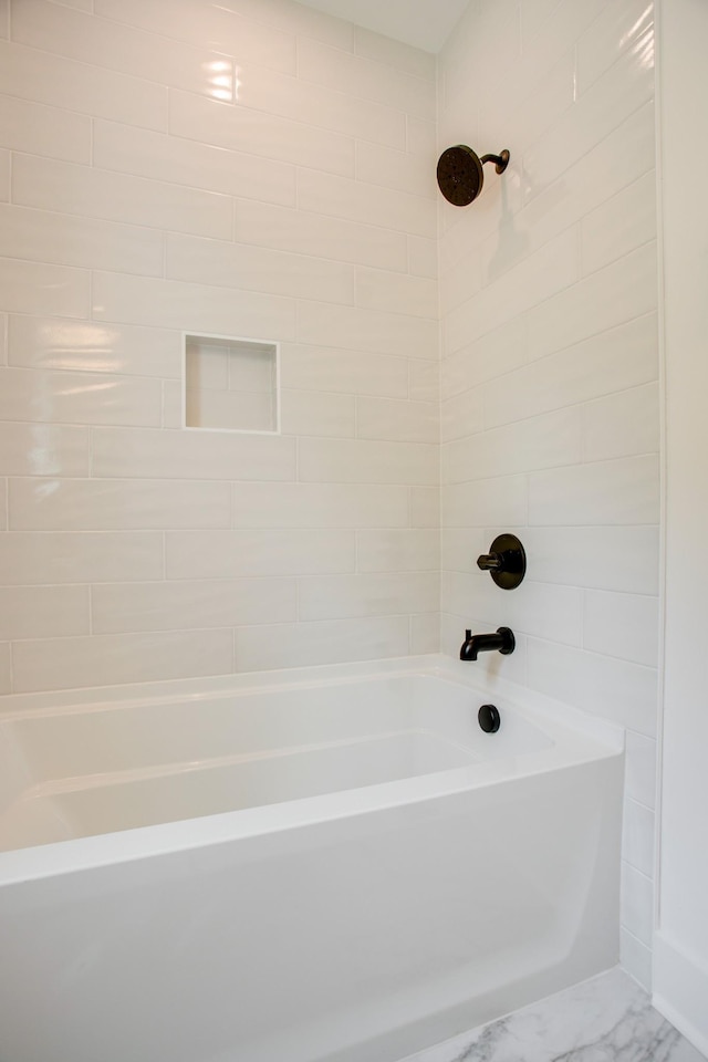 bathroom featuring tub / shower combination and marble finish floor