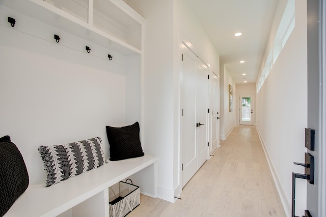 mudroom featuring recessed lighting, light wood-style floors, and baseboards