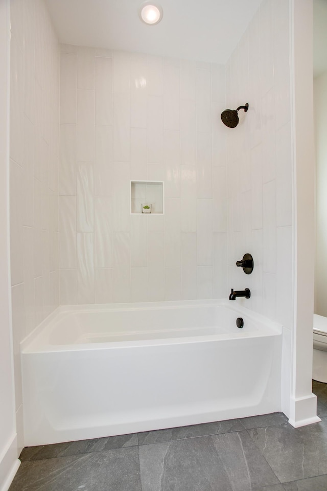 bathroom featuring toilet and washtub / shower combination