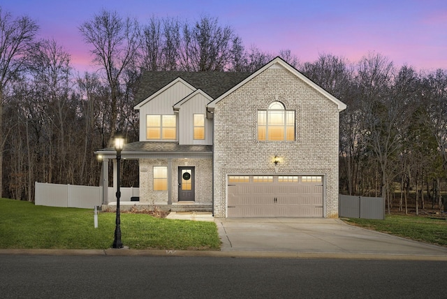 view of front of home with brick siding, a yard, fence, and board and batten siding