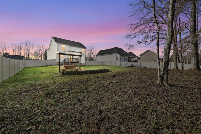 yard at dusk with a fenced backyard