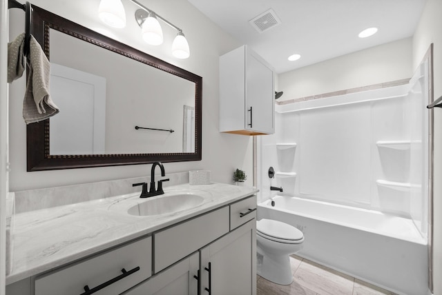 bathroom featuring visible vents, toilet, shower / washtub combination, recessed lighting, and vanity