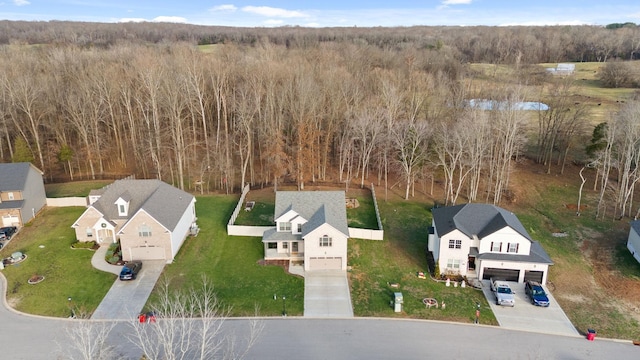 aerial view featuring a forest view and a residential view