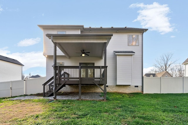 rear view of property featuring a deck, fence, a yard, ceiling fan, and stairs