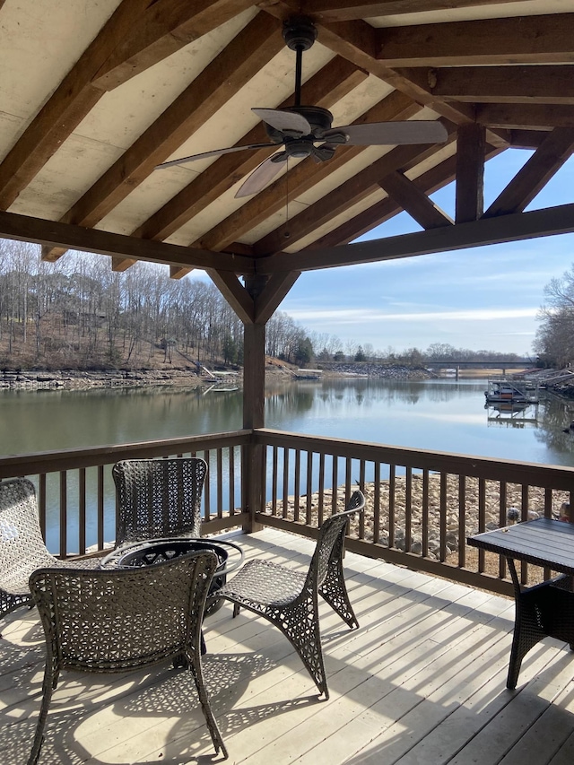 deck featuring a water view and ceiling fan