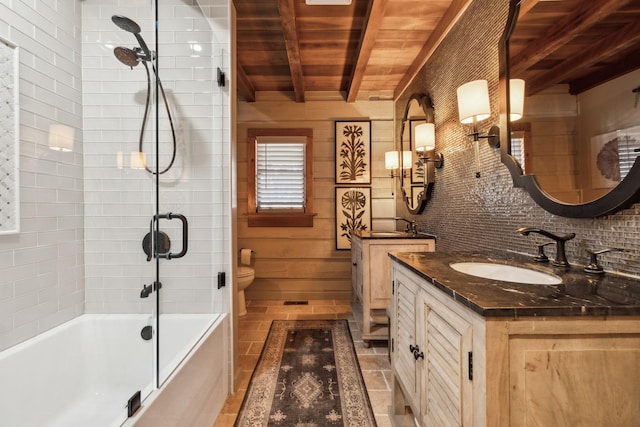 full bathroom featuring vanity, bathtub / shower combination, beamed ceiling, toilet, and tasteful backsplash