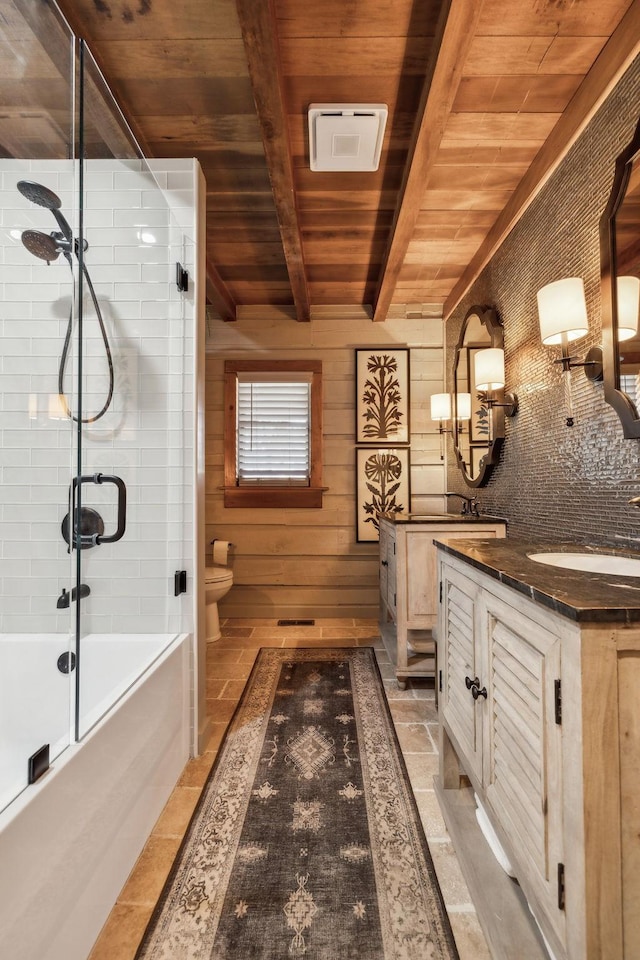 bathroom featuring beam ceiling, toilet, a sink, double vanity, and wood ceiling
