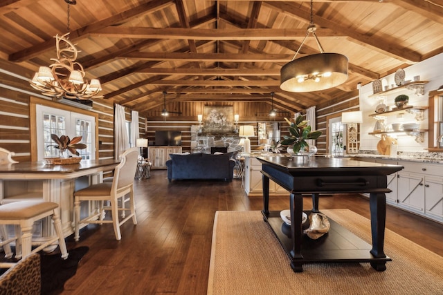 dining space featuring dark wood finished floors, an inviting chandelier, wooden ceiling, a fireplace, and vaulted ceiling with beams