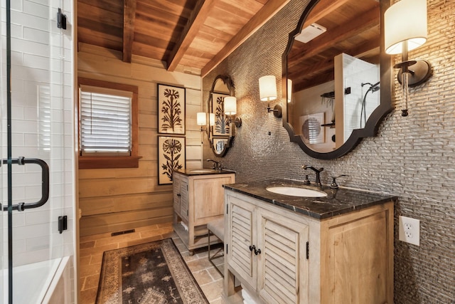 full bathroom with beam ceiling, wood ceiling, a shower with shower door, and a sink