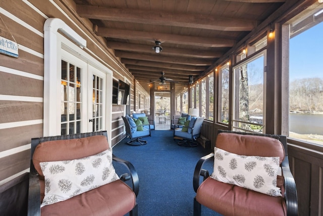 sunroom / solarium with beam ceiling, french doors, and ceiling fan