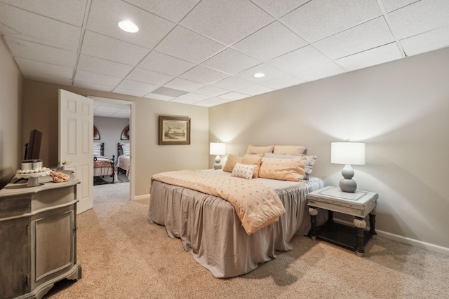 bedroom with a paneled ceiling, baseboards, light carpet, and recessed lighting
