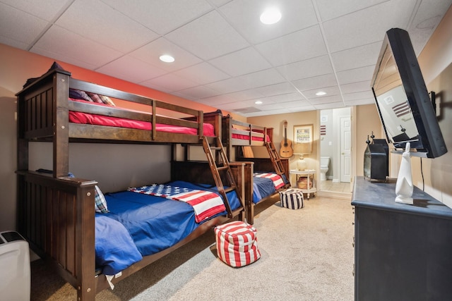 bedroom with a drop ceiling, recessed lighting, and carpet