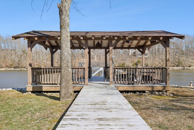 view of dock featuring a gazebo, a yard, and a deck with water view