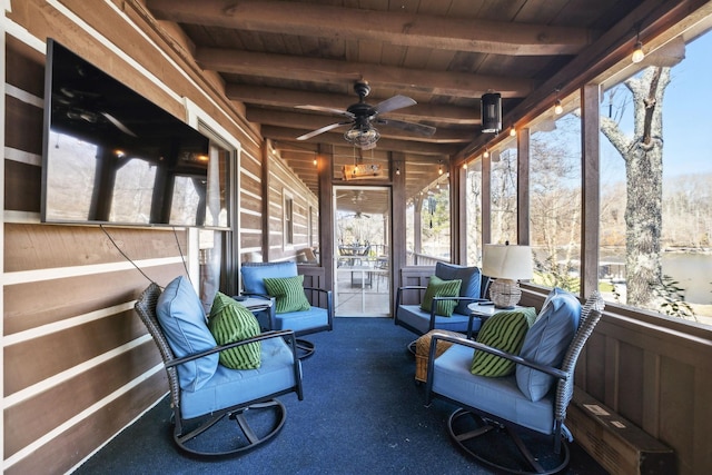 sunroom featuring beam ceiling and ceiling fan