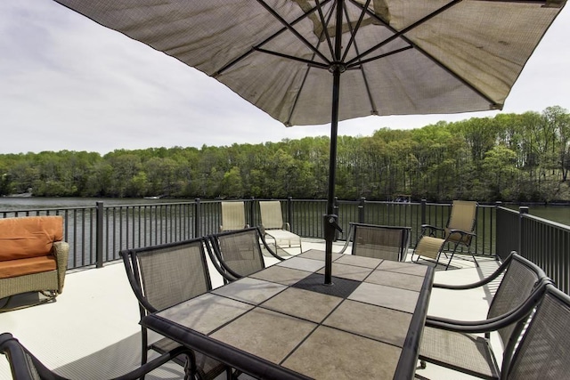view of patio with a forest view and outdoor dining space