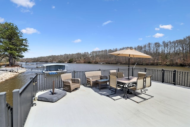 exterior space with outdoor dining space and a water view