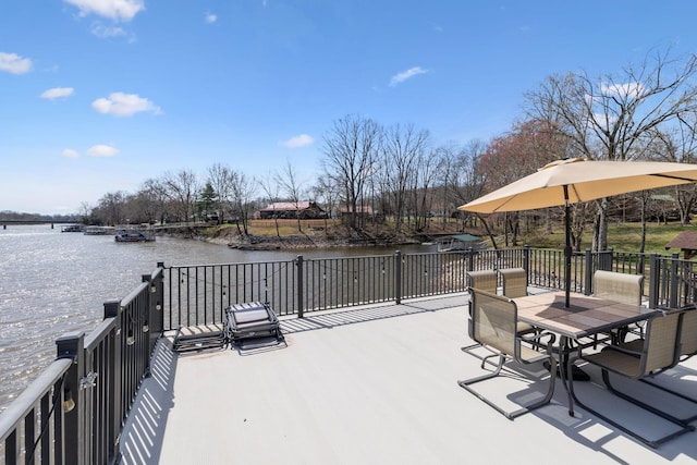 exterior space featuring outdoor dining space and a water view