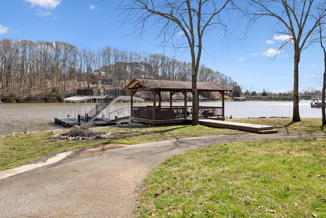 dock area featuring a gazebo, a yard, and a water view