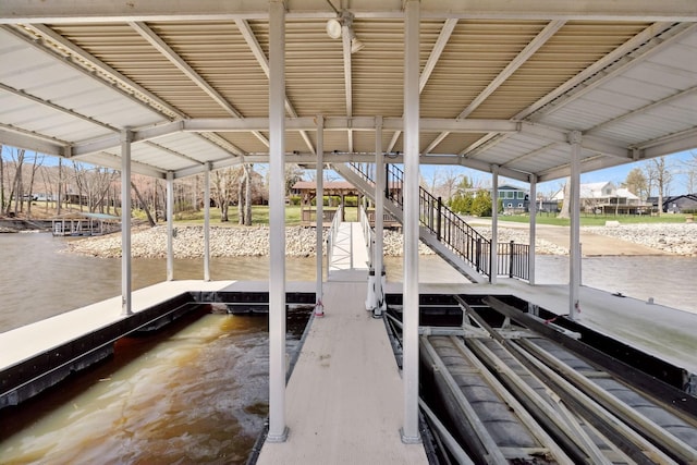 dock area featuring stairway and a water view