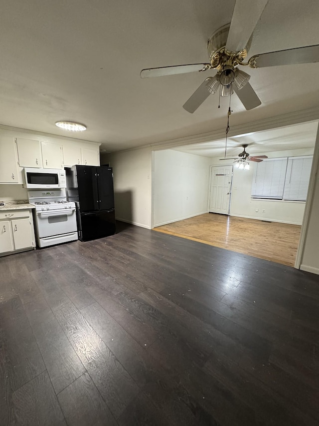 kitchen featuring dark wood finished floors, white appliances, white cabinets, and open floor plan