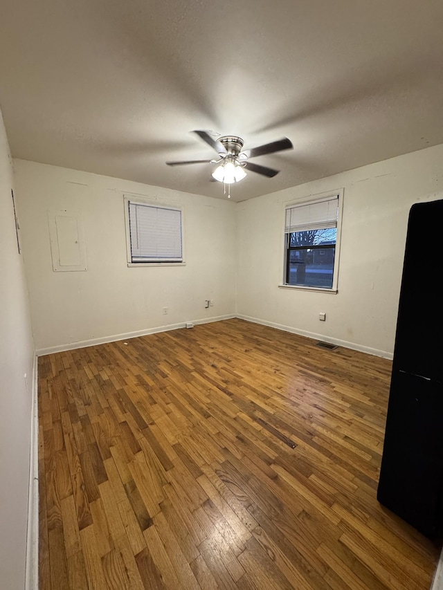 unfurnished bedroom with wood finished floors, baseboards, and ceiling fan