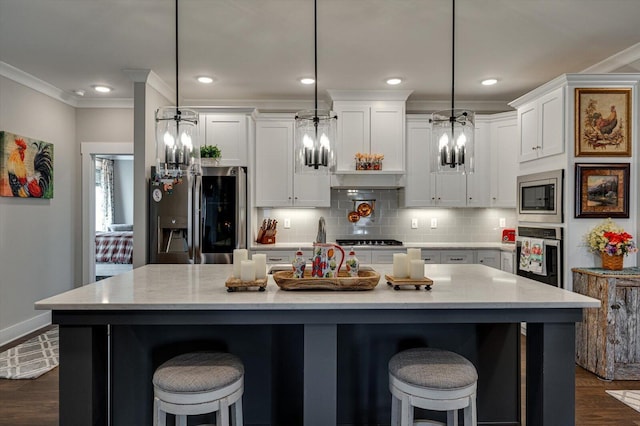 kitchen featuring white cabinets, ornamental molding, backsplash, and stainless steel appliances