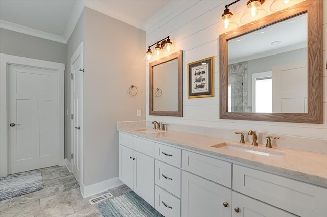 bathroom featuring visible vents, ornamental molding, and a sink