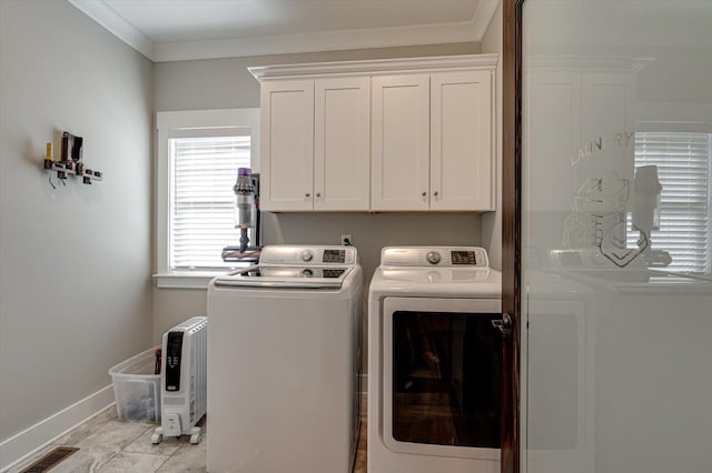 washroom with visible vents, independent washer and dryer, ornamental molding, cabinet space, and baseboards