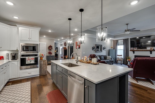 kitchen with a sink, stainless steel appliances, gray cabinetry, and open floor plan