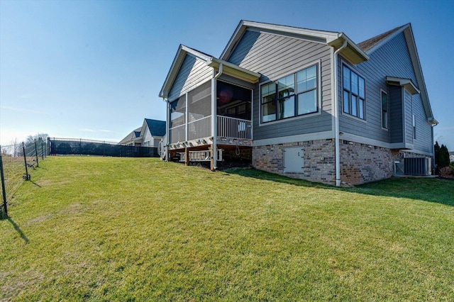 exterior space with a front lawn, central AC, fence private yard, and a sunroom