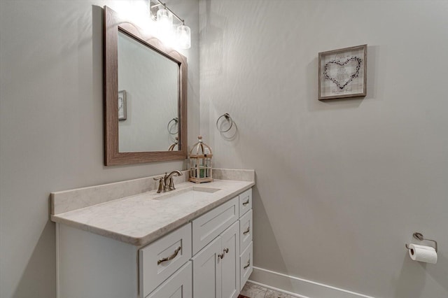 bathroom with vanity and baseboards