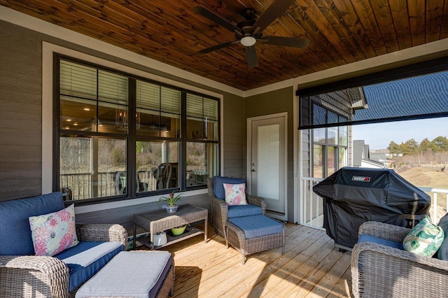 sunroom / solarium featuring wooden ceiling and a ceiling fan