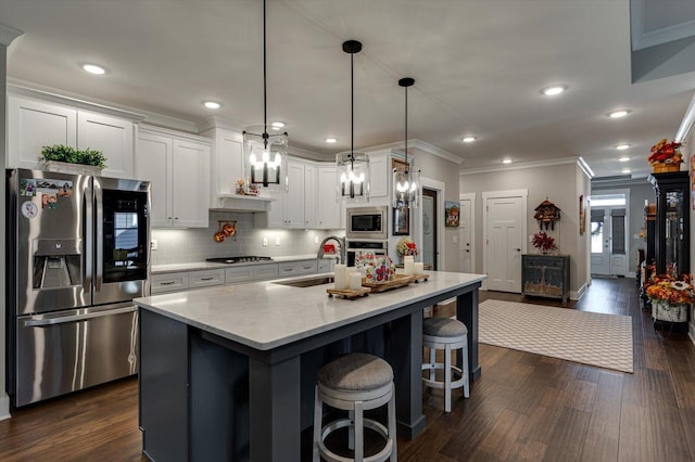 kitchen with a sink, dark wood-style floors, tasteful backsplash, and stainless steel appliances