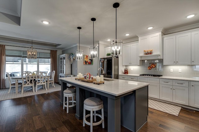 kitchen with decorative backsplash, stainless steel appliances, dark wood-type flooring, and a sink