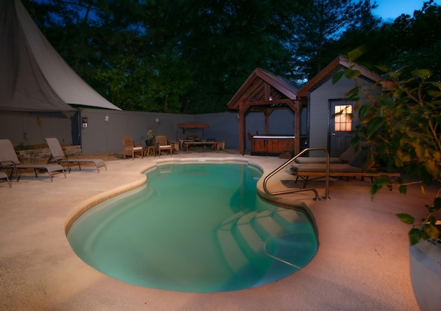 view of pool featuring a fenced in pool, a hot tub, fence, a gazebo, and a patio