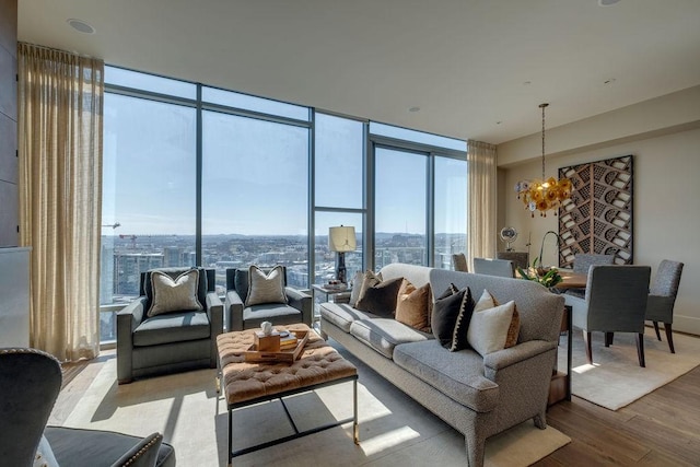 living area with a notable chandelier, wood finished floors, and expansive windows