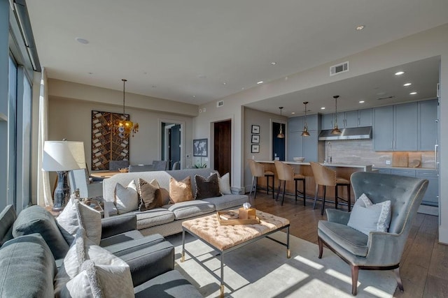 1212 Laurel St Unit 2303, Nashville, TN 37203 - living room featuring an inviting chandelier, recessed lighting, wood finished floors, and visible vents