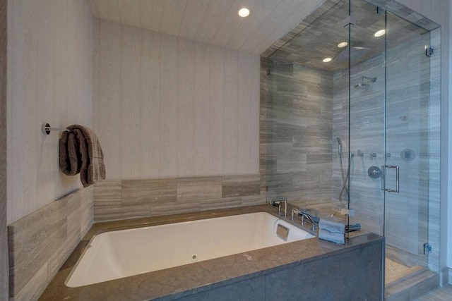 full bathroom featuring a garden tub and a stall shower